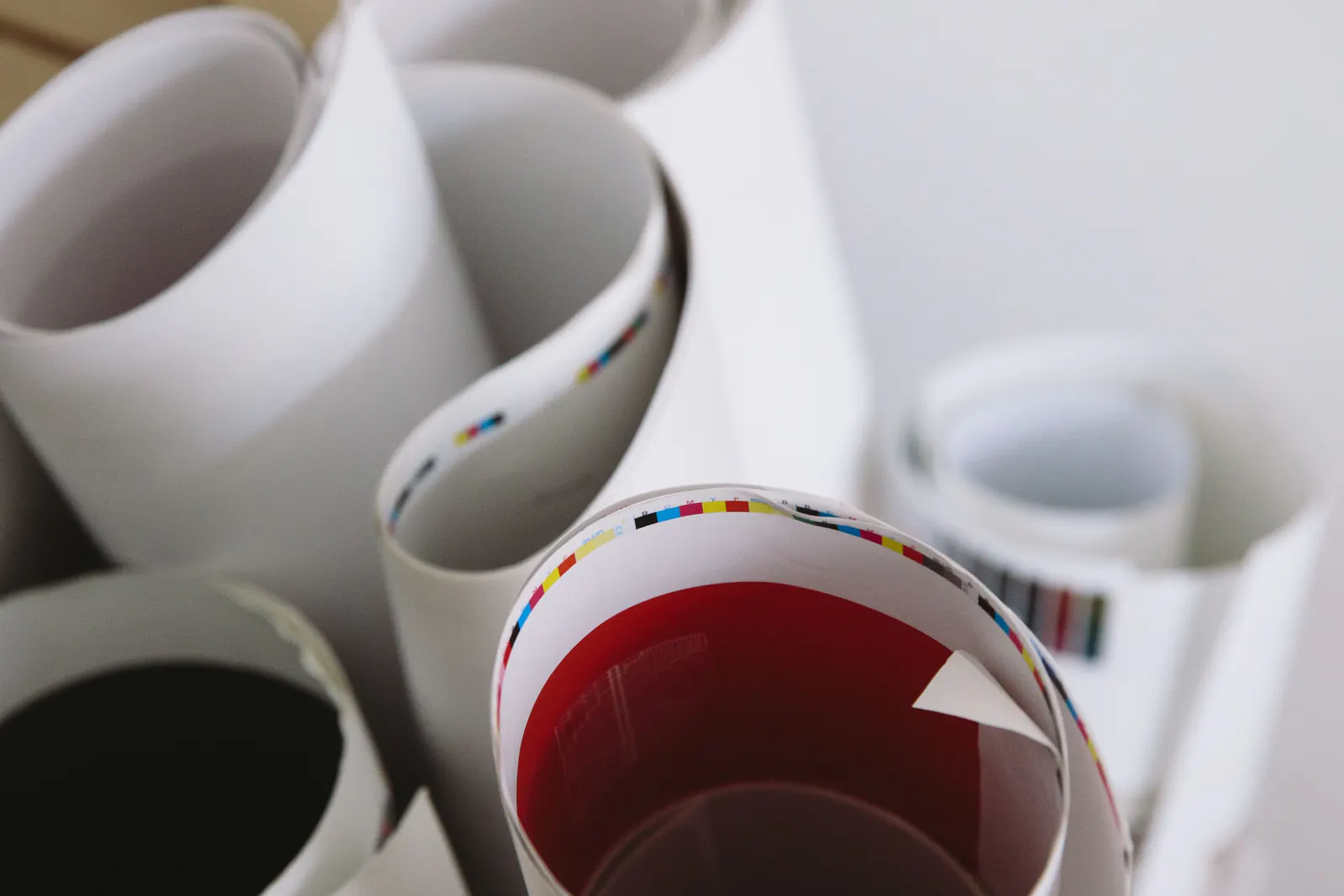 Rolled printed posters showing colourful paper edges and print details.